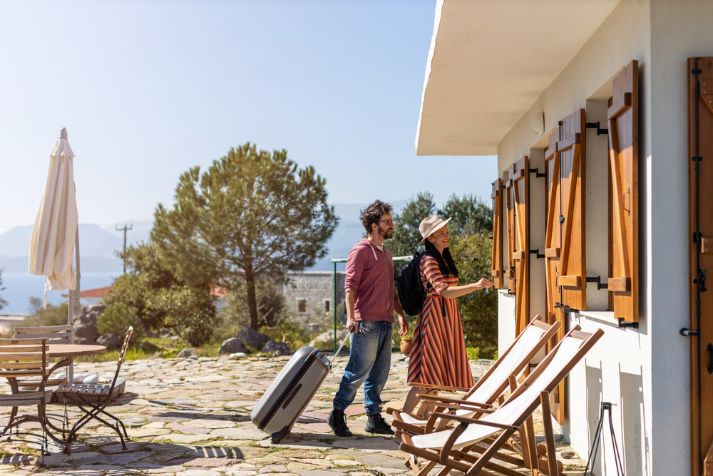 Young,Couple,Arriving,To,At,Holiday,Home